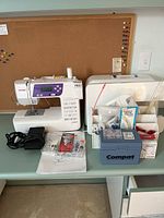 Sewing machine with accessories laid out