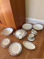 Full lot showing plates, serving bowls, teacups, creamer