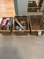 Three woven baskets, two containing knitting supplies, one empty