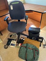 Group shot showing chair, shredder, phone, bags, cables and mat