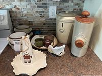 Group shot showing foot warmer, Marshall crock, soup bowls, mixing bowls, platters, small bowls and novelty flask