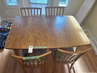 Top view of wood dining table showing grain and 2 chairs