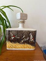 Front view showing duck scene and stopper