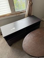 TV stand dark wood two shelves, window behind