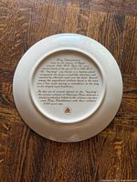 Plate reverse showing printed historical text and maker mark