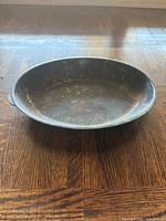 Top view of round electroplated copper tray showing patina and left side handle