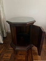 Both tables show octagonal shape, glass top, door open revealing storage