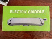 Front of green box showing electric griddle image and product name