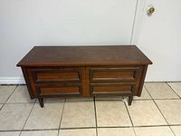 Closed chest front view showing faux drawer fronts and legs