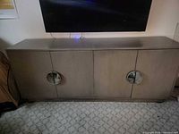 Front view of closed sideboard showing four doors and metal pulls