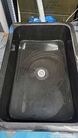 Top view of dark granite composite sink interior