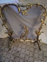 Front view showing full brass frame and mesh panel