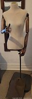 Full mannequin front view showing torso, wood arms and stand