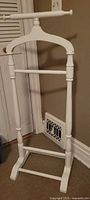 Front view of white wooden valet rack