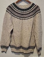 Front view of sweater on hanger