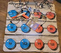 Full view of Nintendo Power Pad with controllers, Zapper and manual on top