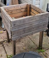 Full view of planter showing slatted wood sides and legs