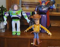 Woody, Buzz Lightyear and Zurg figures on shelf