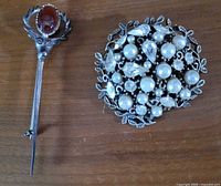 front view of both brooches