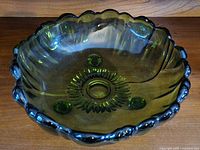 Top view showing Sunflower pattern, scalloped rim and green glass coloration
