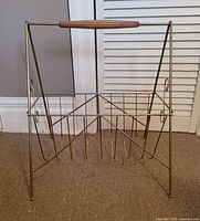 Front view of metal record rack showing dividers and legs