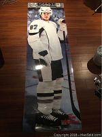 Photo of laminated full-length life size growth chart of Sidney Crosby in hockey uniform with growth markings and Tim Hortons logo.