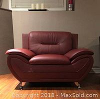 Front view of red faux leather armchair