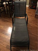 Full view of the pool lounger chair showing the mesh seating and backrest with armrests and metal frame structure.