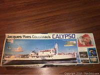 Box front showing the ship Calypso with title and Cousteau's photo.