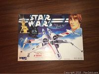 Photo of the front of the sealed box showing X-Wing Fighter artwork, Star Wars logo, Luke Skywalker's image, and TIE Fighters, confirming the item is an authentic 1978 model kit by MPC.