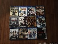 Photo showing full collection of 12 Blu-ray movie cases arranged in three rows of four cases each on a dark surface.