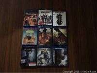 Nine Blu-ray movie cases arranged in three rows, titles visible including Ocean's Eleven, Ocean's Twelve, Ocean's Thirteen, We're the Millers, Behind Enemy Lines, Behind Enemy Lines II, The Book of Eli, The Marked Ones, and Robocop.