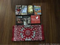 Overview of DVDs and red bandana laid on wooden surface