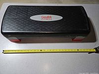 Top view of GoodLife Fitness aerobic step platform with tape measure for scale
