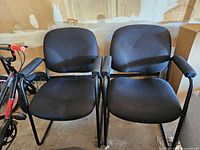 Front view of both black sled-base chairs