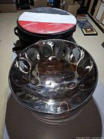 Steelpan inside and atop padded bag on table