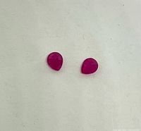 Both pear-shaped rubies side by side showing size and shape