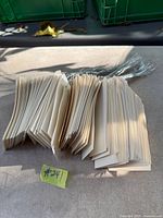 Stacks of beige card stock tags with attached wires