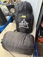 Shot of two packed sleeping bags; one branded RBSM Sports, the other plain