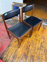Pair of Danish rosewood chairs side by side on wooden floor