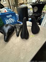 Top view of four bicycle seats on table