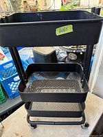 Full view of cart front showing three mesh tiers and casters