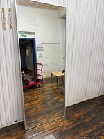 Front view showing full length of mirror and slim silver frame