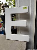 Front view of large white letter E showing overall shape and finish