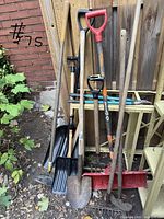 Group view of all eight tools leaning against fence
