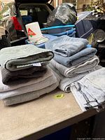 Two stacks of assorted towels on table