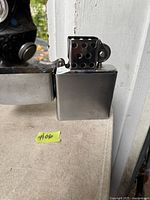 Lighter open showing chimney, thumbwheel and interior