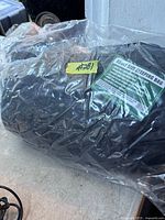 Sleeping bag sealed in plastic with label visible