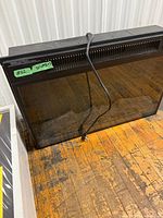 Front view of electric fireplace insert showing glass front and power cord