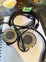 Full view of Grado PS500 headphones coiled on notebook showing headband and earcups